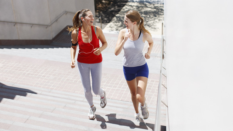 Friends running together up stairs