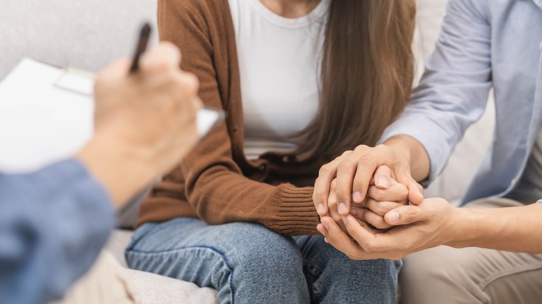 couple holding hands in therapy