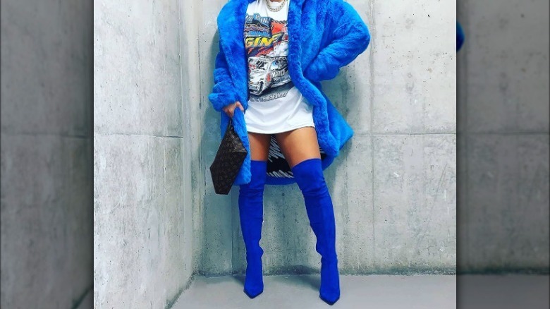 Model wearing blue suede boots