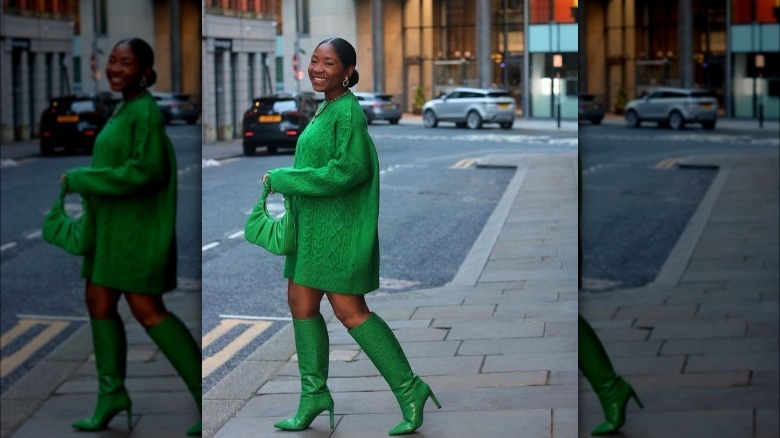 Model wearing monochrome outfit with green boots