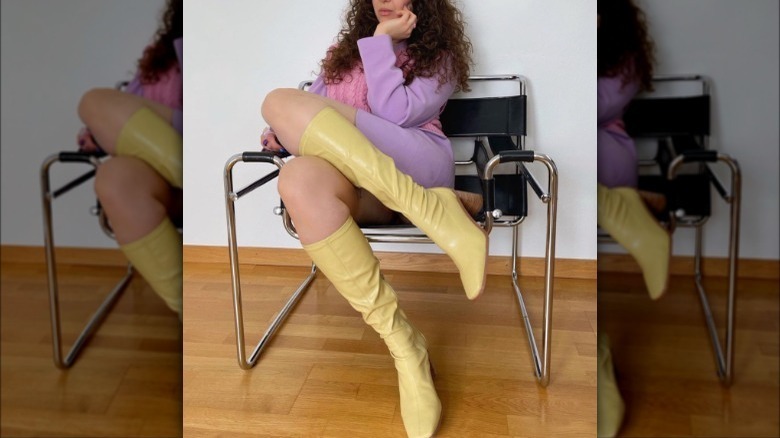 Model wearing lemon yellow knee-high boots