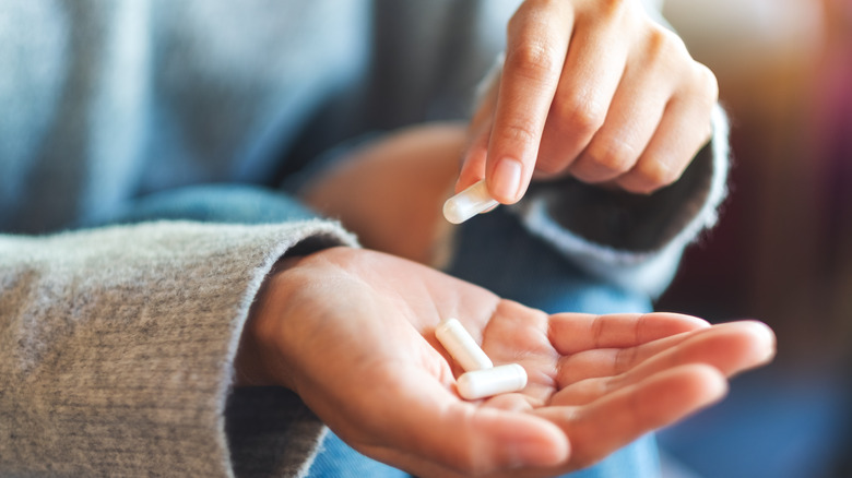 Person holding pain pills