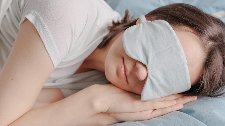 person wearing eye mask sleeping