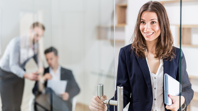 woman walking through office door 