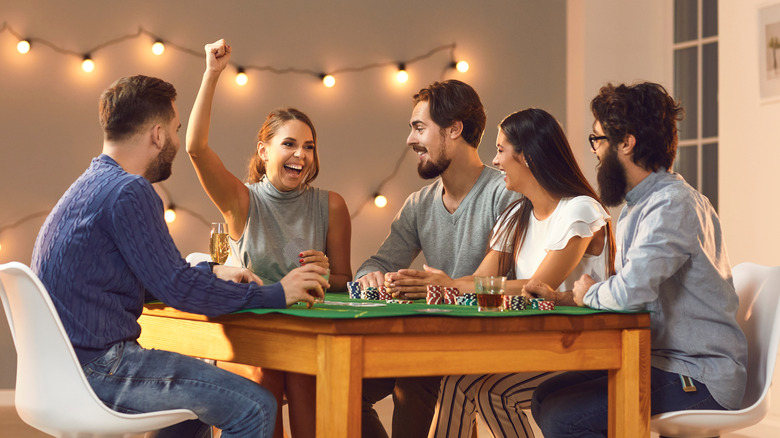 friends playing game on table