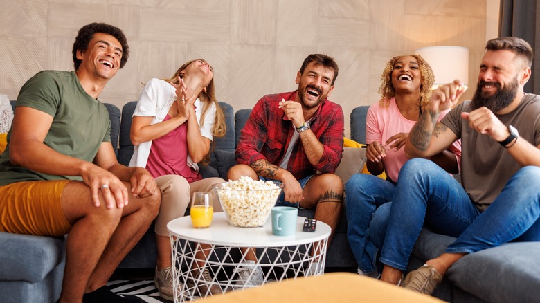 friends eating popcorn and laughing