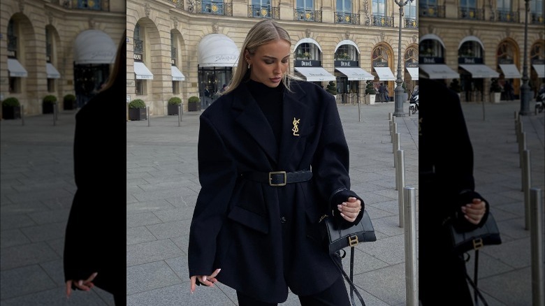 Woman in black belted coat 