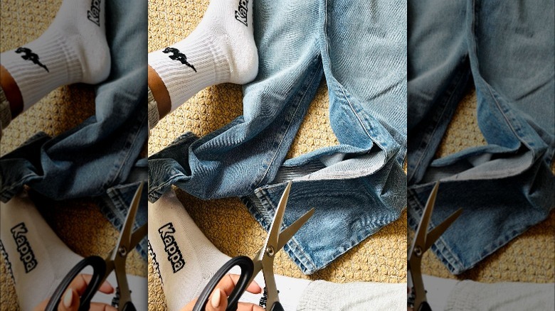 Close-up of scissors over denim pants