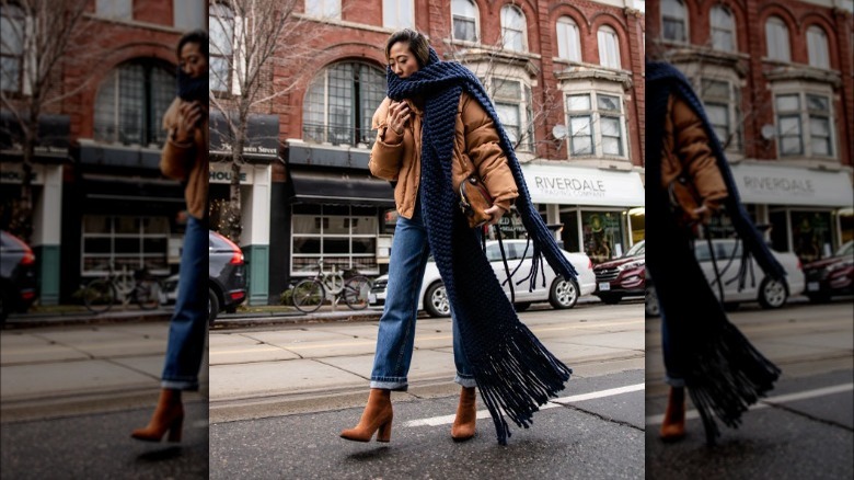 Woman wearing winter outfit with cuffed jeans