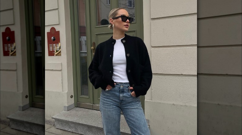 Woman wearing black cardigan and jeans