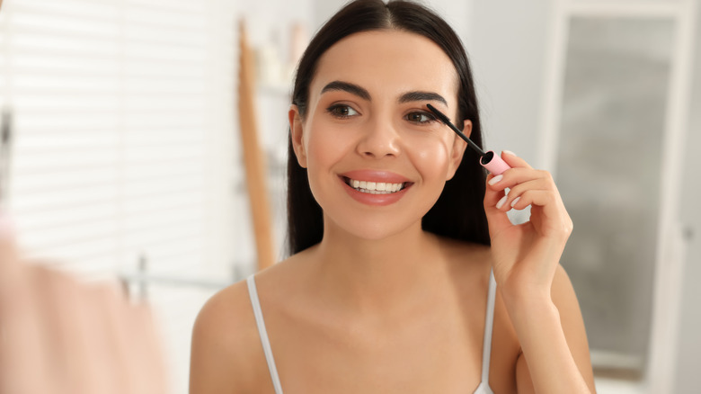 Woman applying mascara