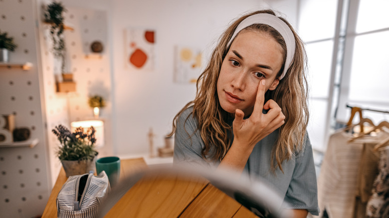 Woman applying eye cream