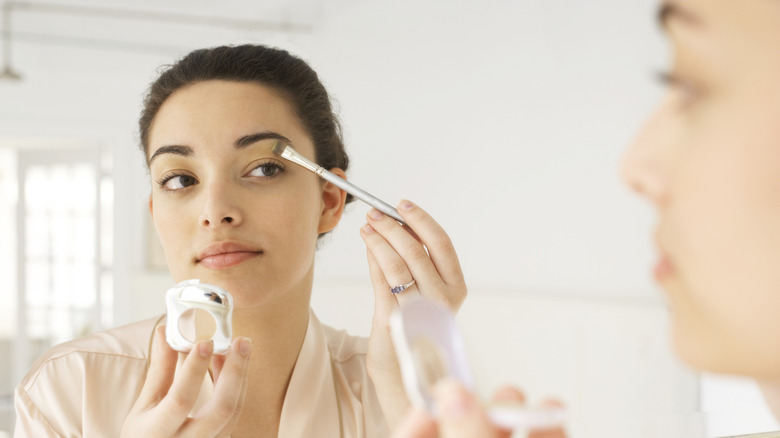 Woman applying eyeshadow