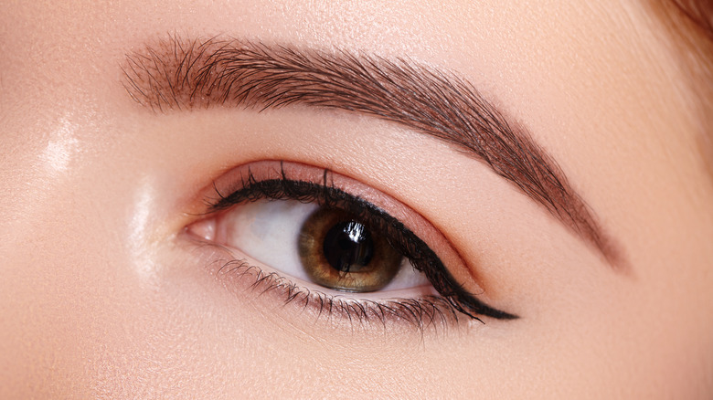 A woman wearing white eyeliner on her waterline