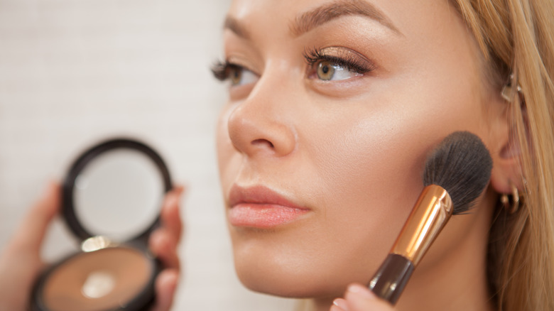A woman applying makeup
