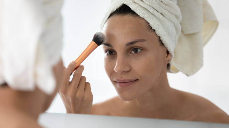 A woman applying makeup