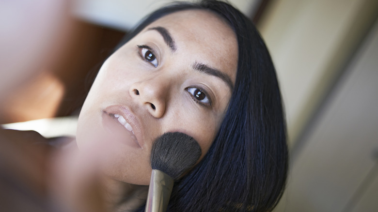 Woman applying face powder