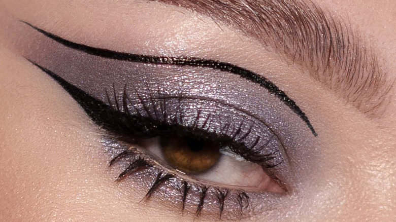 Graphic eyeliener with purple gray shadow