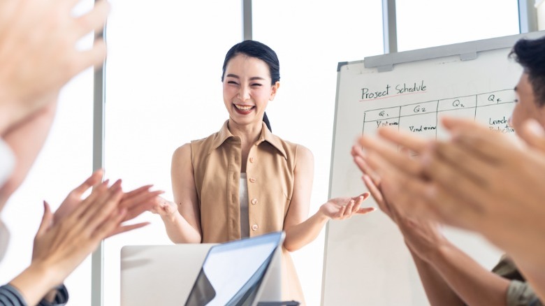 Business woman smiling at presentation 