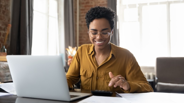 Woman working at desk with laptop