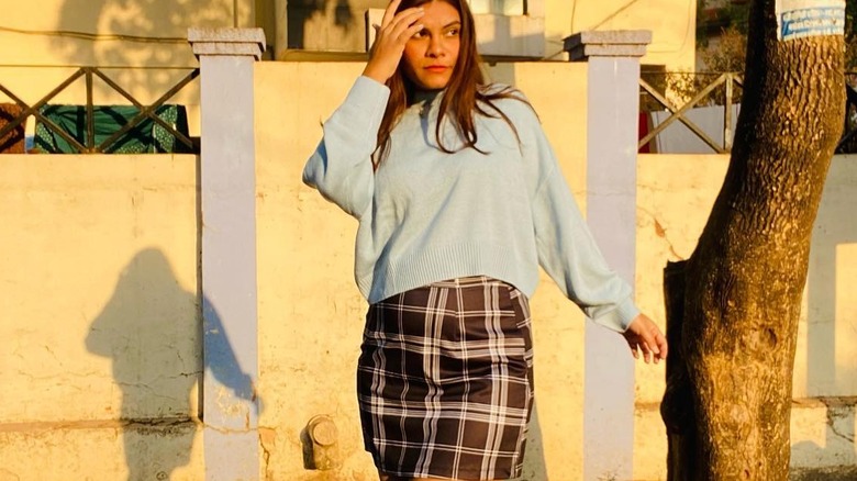 Blue sweater and plaid skirt