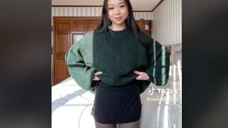 Green sweater and black skirt