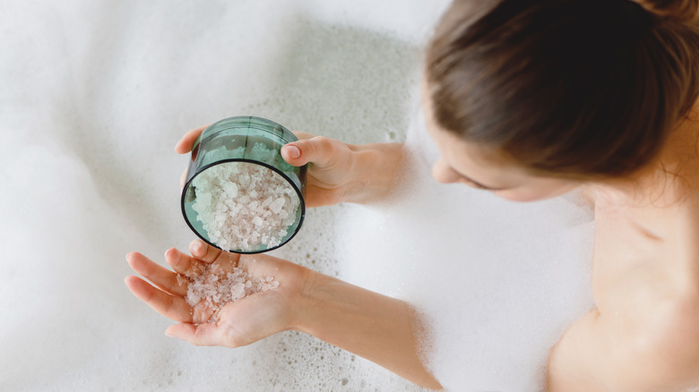 woman pouring salt onto hands