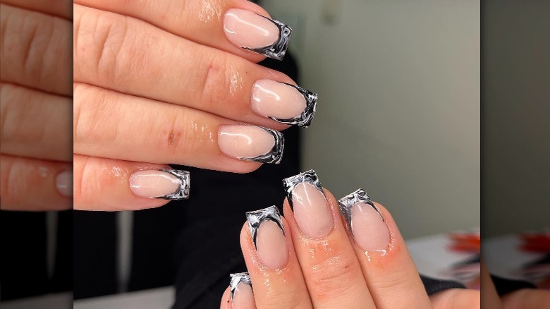 Instagram user @a_la_madame with black and white marbled french manicure