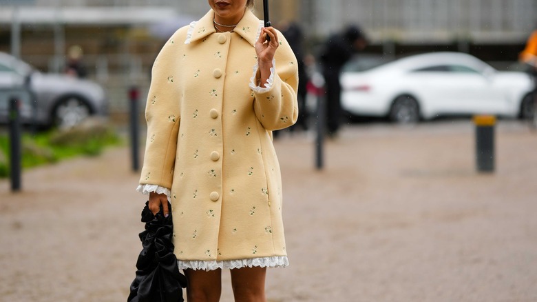 woman wearing margarine yellow coat