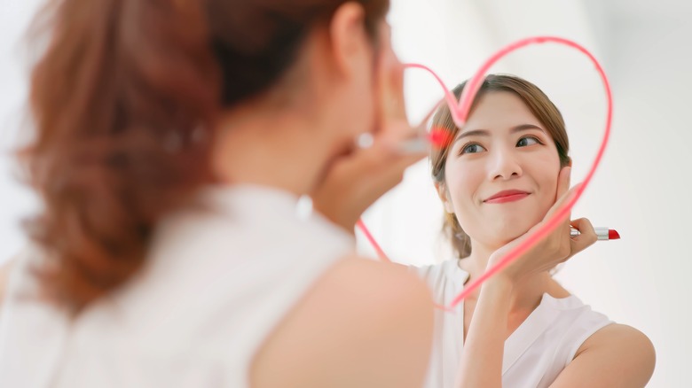 Woman looking confidently in the mirror.