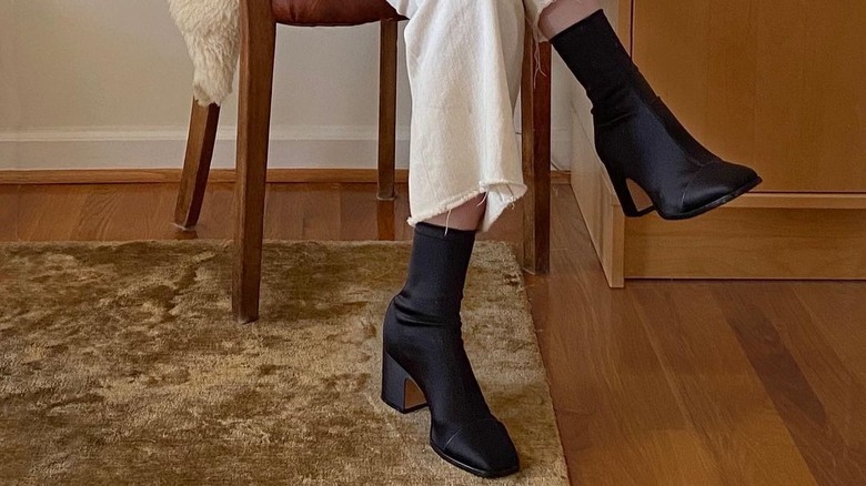 woman wearing satin boots