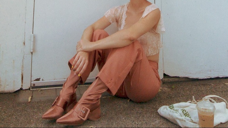 woman wearing satin boots