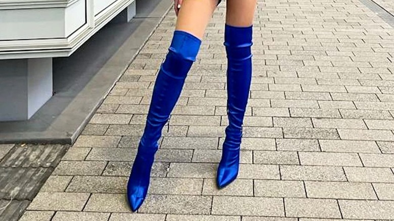 woman wearing satin boots