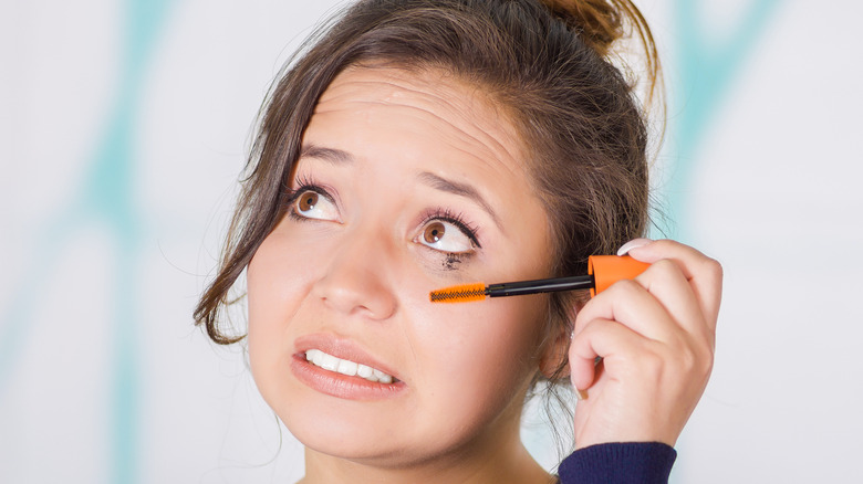 Woman making mess with mascara