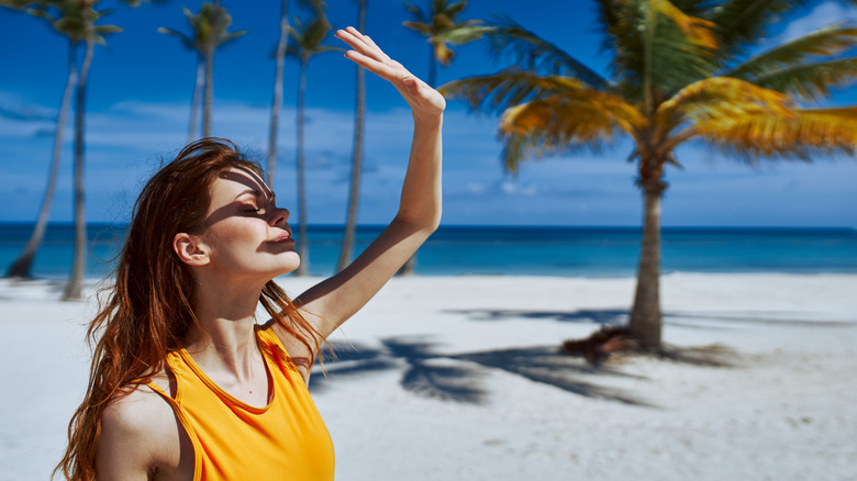 Woman on beach with shadows