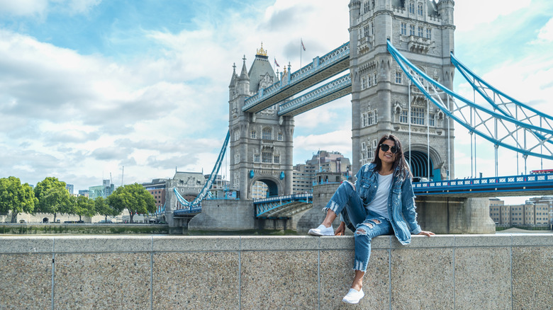 Woman sitting at London Tower Bridge