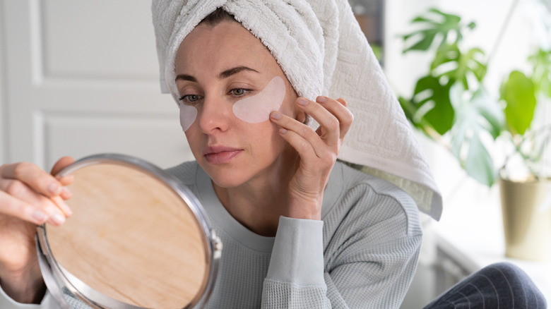 Woman sealing moisture under eyes