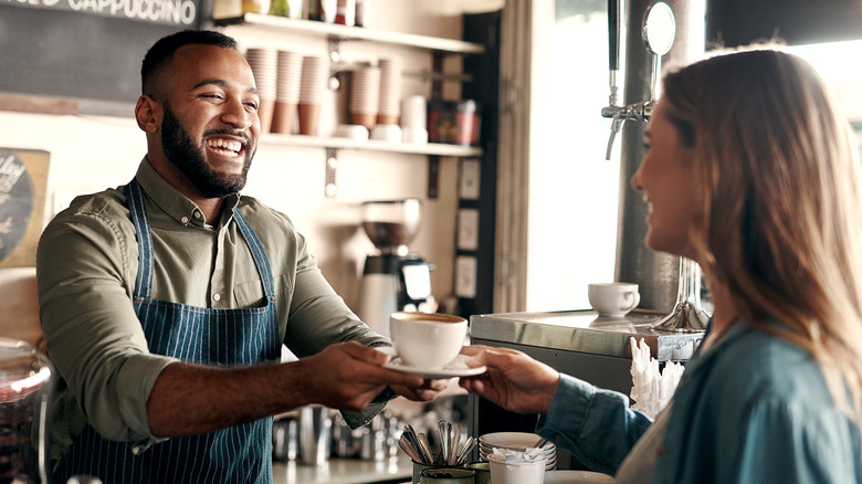 barista and customer holding eye contact