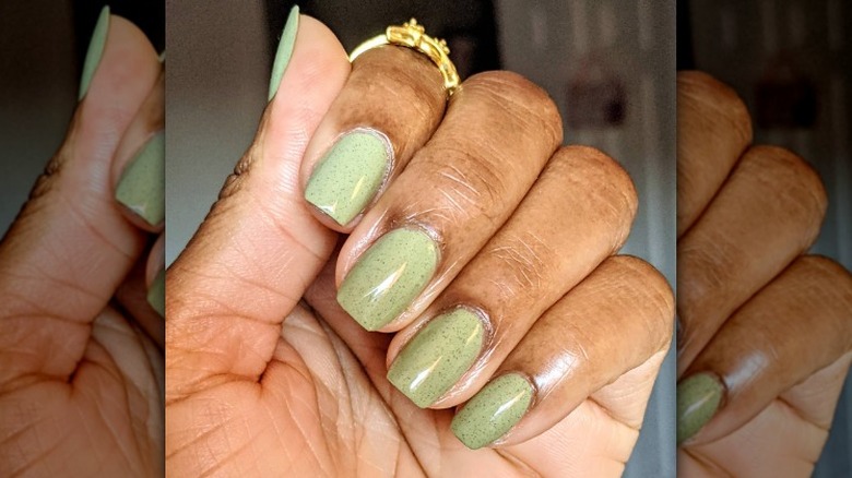 green nails and gold ring