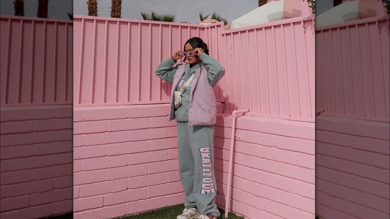 Girl wearing a sweatsuit with accessories.