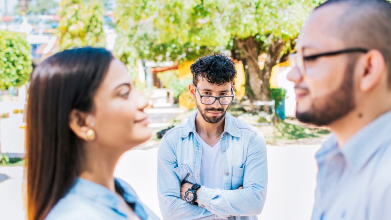 Three people standing outside