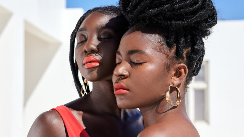 two women wearing orange lipstick