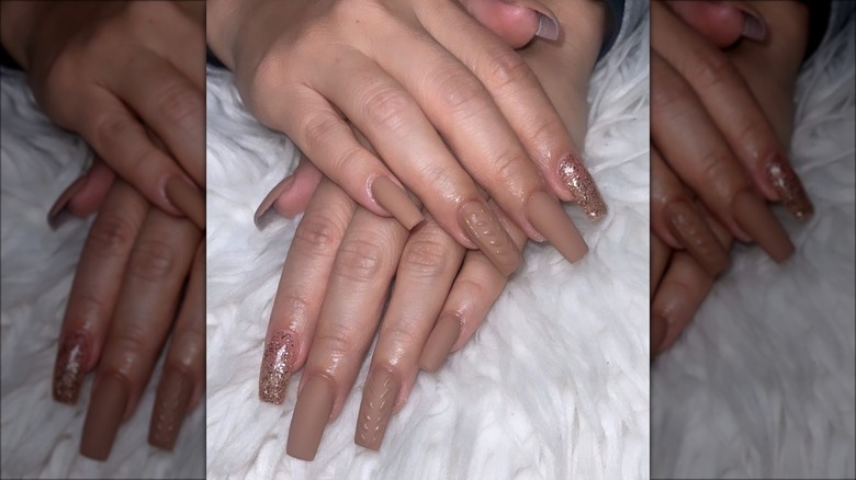 Woman with brown and gold nails
