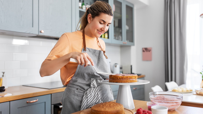 Woman happily bakes cake