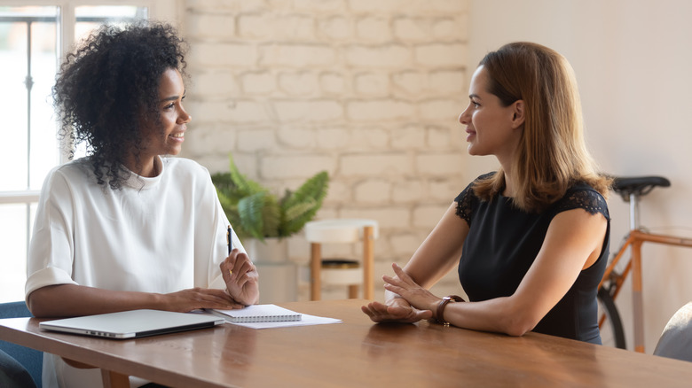 boss and worker talking at table 