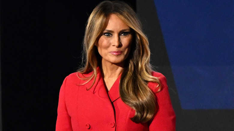 Melania Trump smiling with smokey eye makeup