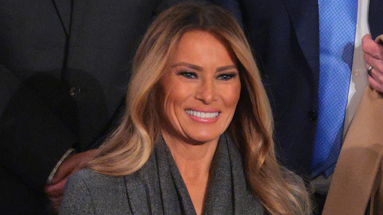 Melania Trump wearing a gray jacket