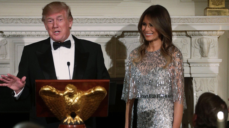 Melania Trump and Donald Trump addressing an audience at the White House