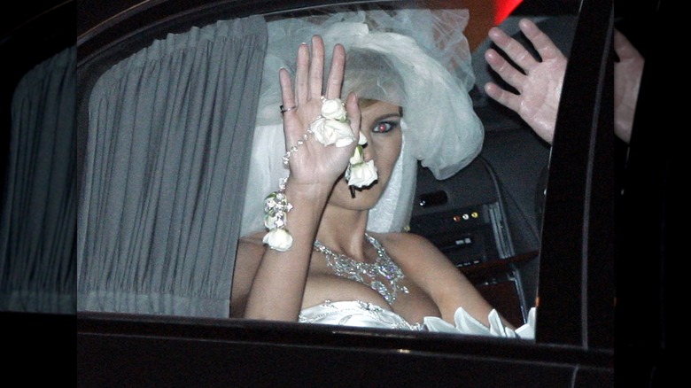 Melania Trump in the car on her wedding day, wearing a white dress and veil