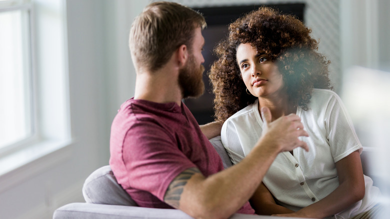 Couple talking on sofa